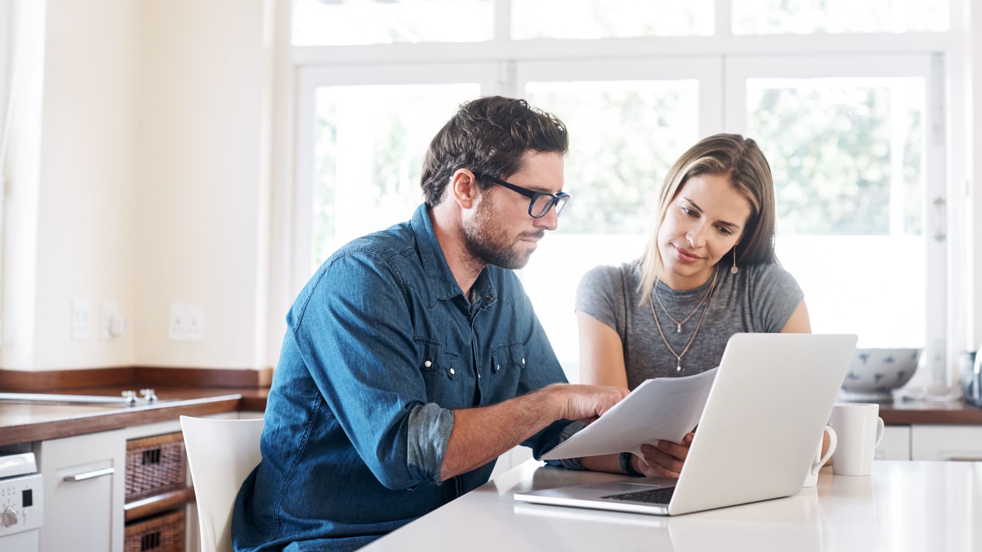 Shot of a young couple working on their finances together at home