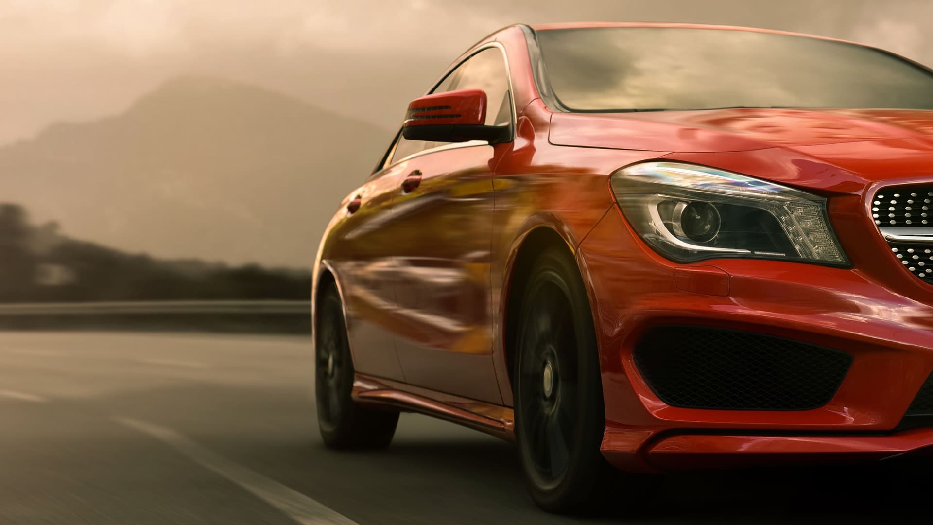 Ein rotes Auto fährt schnell in eine Kurve.