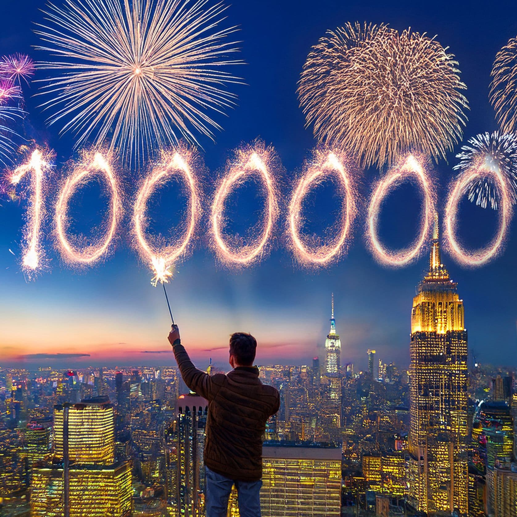Ein Mann steht auf einem Hochhaus über einer Großstadt bei Sonnenuntergang und schreibt mit einer Wunderkerze die Zahl „1.000.000“ in den Himmel, während im Hintergrund bunte Feuerwerke den Himmel erleuchten.