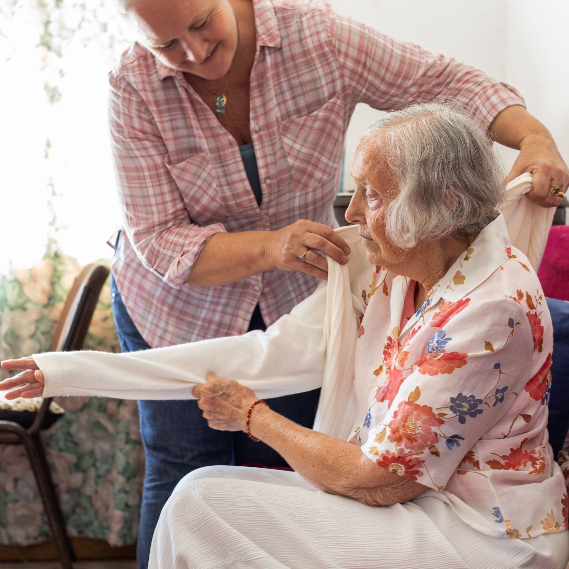 Reife Frau kümmert sich um ihre alte Mutter